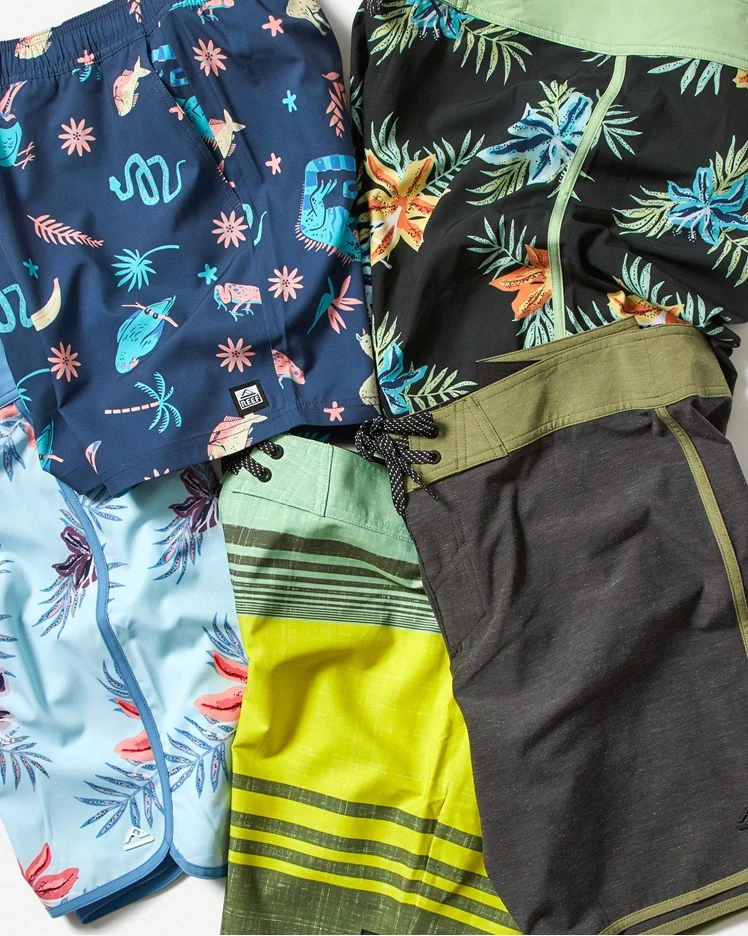 Collection of mens board shorts folded next to each other