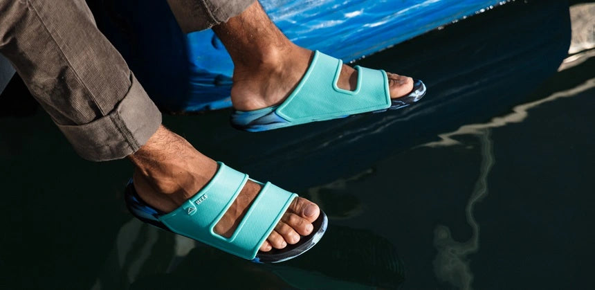 Footwear Oasis in blue dangling off boat close up