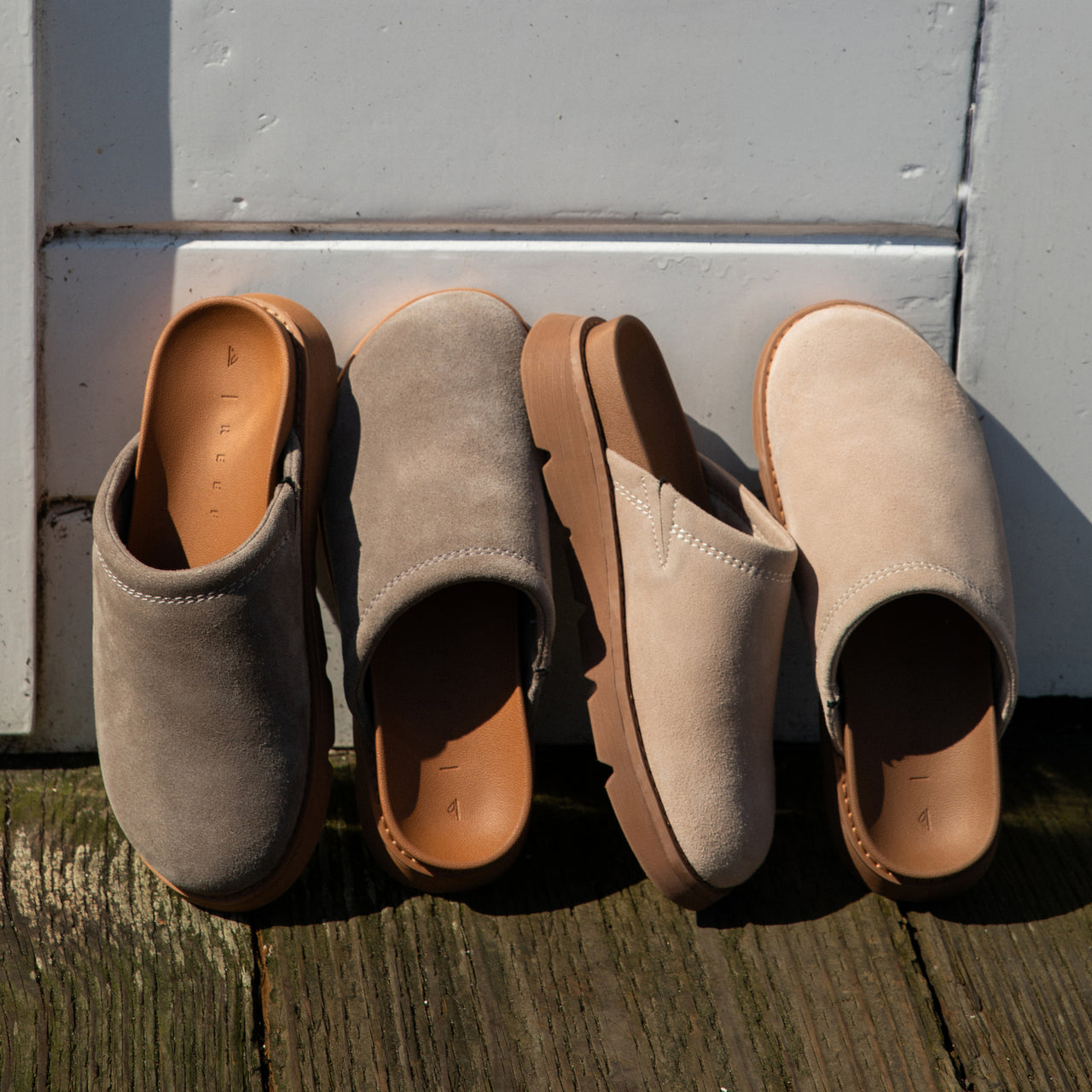 Four pairs of Vista Luxe Mariana clogs, suede upper facing up, highlighting cushioned footbed and arch support.