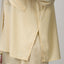Ellie Button Up showing side slit and part of hem with yellow and white thin stripes on lightweight fabric