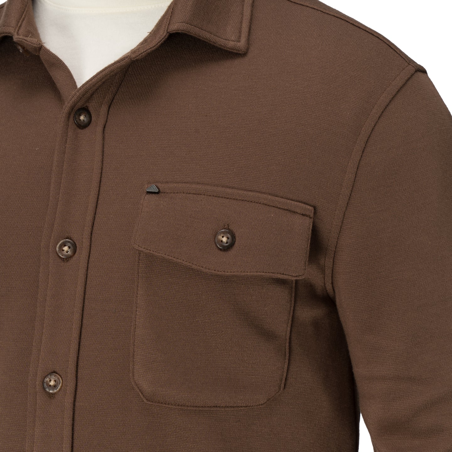 Close-up of the Coltrane Pique Shirt front pocket and upper chest in brown, showcasing its relaxed, comfortable beach-inspired design.