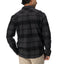 Back view of man wearing Reggie Flannel Shirt in dark plaid, showcasing comfort-focused surf-inspired apparel.