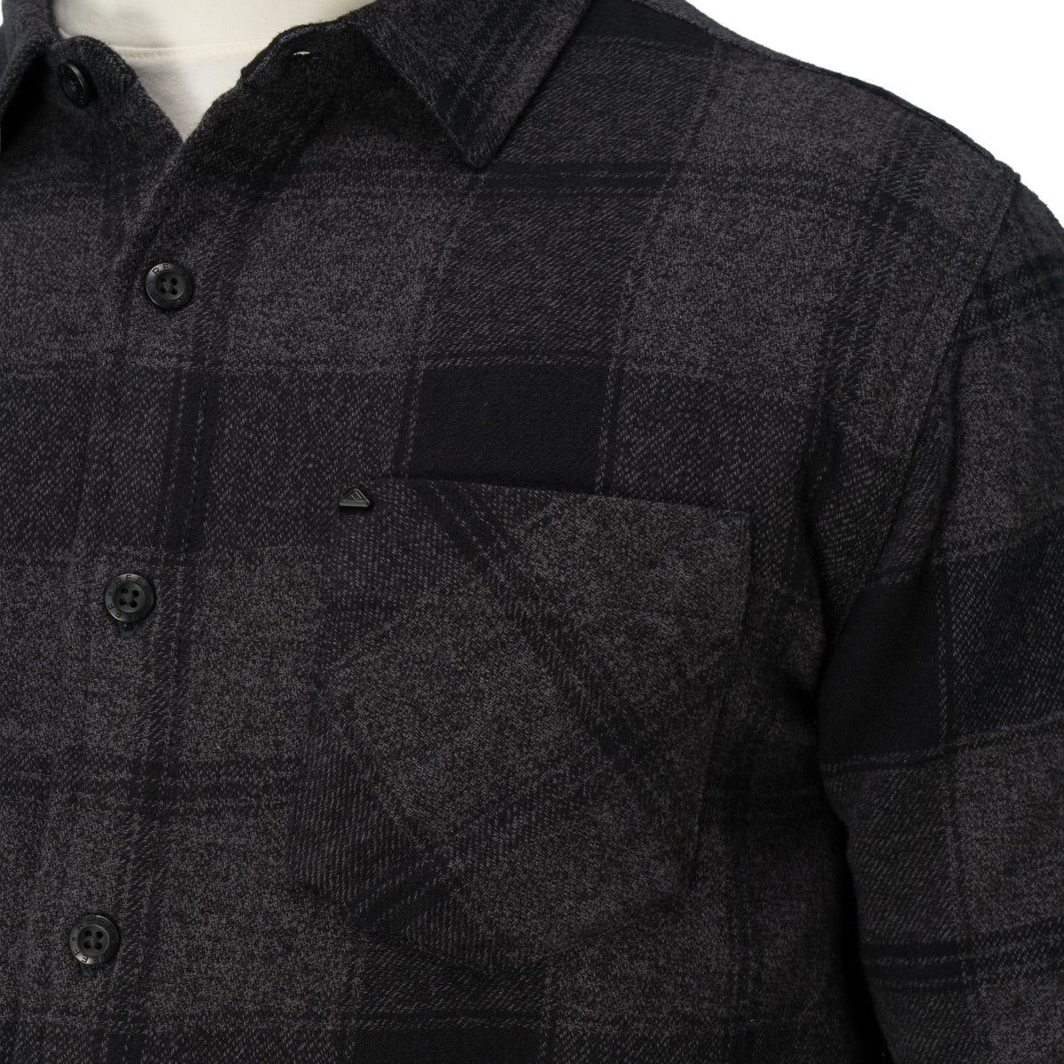Close-up of the chest pocket and buttons on the Reggie Flannel Shirt in dark gray plaid from StoreRank.ai All Products.
