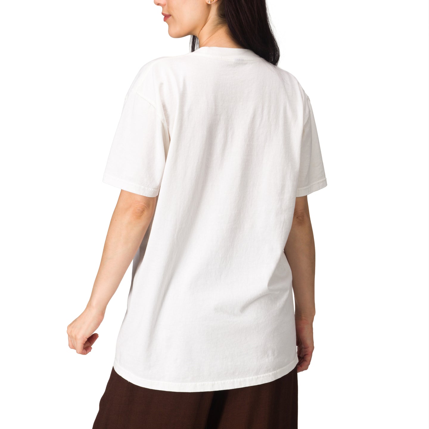 Rear view of a model wearing the Lia Boyfriend Crew oversized white tee in a relaxed, beach-inspired style.