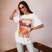 Model wearing Lia Boyfriend Crew tee with sun-faded print, oversized fit, showcasing beach-inspired comfort and style.