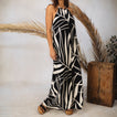 Model wearing the Tori Linen Maxi Dress with black and white abstract print, standing, showing full length and adjustable rope straps.
