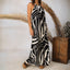 Model wearing the Tori Linen Maxi Dress with black and white abstract print, standing, showing full length and adjustable rope straps.