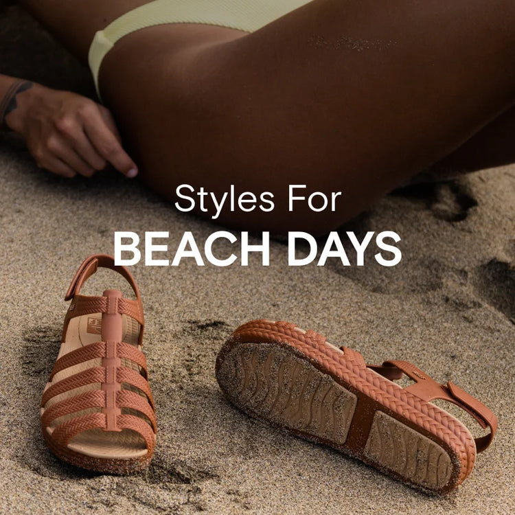 Text reads: "Styles For Beach Days", a photo of a woman laying on the beach with the REEF's Water Beachy Sandals in Brunette 