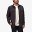 Man wearing dark button-up Raymond Ls Shirt over white tee, with hands in pockets, front view, beach-inspired comfort apparel.