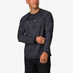 Man wearing a black patterned Dune Performance Shirt facing slightly left, showing front and left sleeve details.