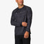 Man wearing a black patterned Dune Performance Shirt facing slightly left, showing front and left sleeve details.