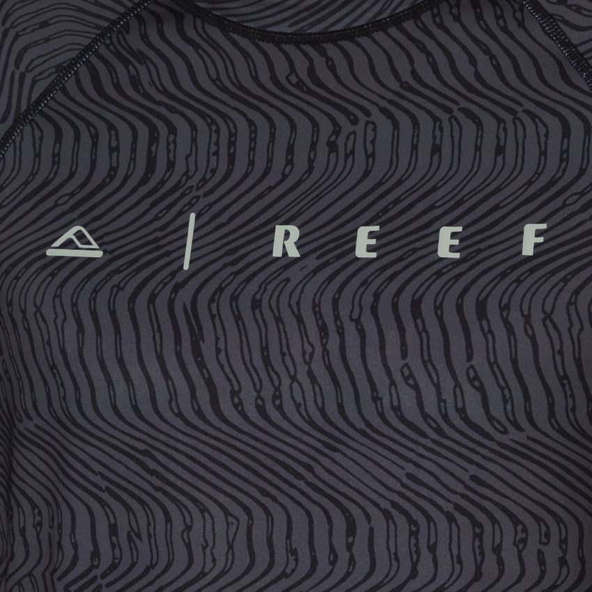 Close-up of the front chest area of the men's Dune Performance Shirt with a black wavy line pattern and REEF logo.