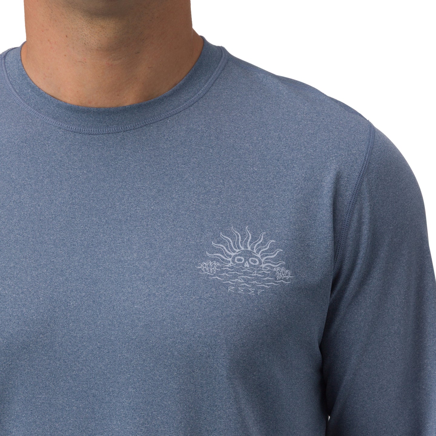 Men’s Set In Performance Shirt in blue with subtle sun and waves graphic on chest, highlighting comfort and durability.