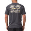 Back view of a man wearing the dark gray Siesta Performance Shirt with a beach hammock graphic and palm trees.