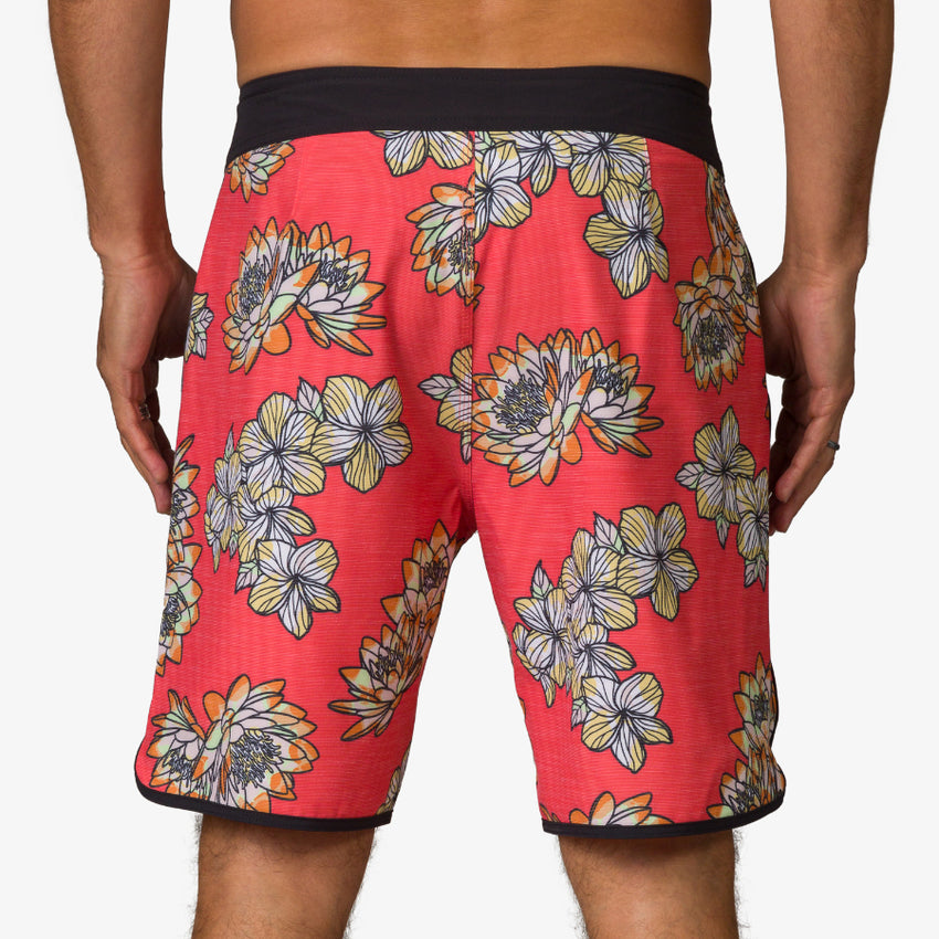 Rear view of men's Tanner Boardshort in coral with floral print and black waistband, designed for beach comfort and durability.