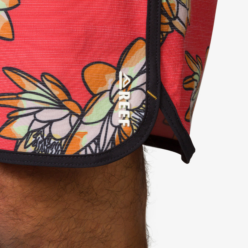 Close-up of Tanner Boardshort hem with floral print and REEF logo, designed for comfort and beach lifestyle.