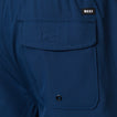 Close-up of the back pocket on the Garland Hybrid Short in navy blue, highlighting the REEF logo and durable stitching.