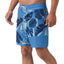 Front view of men's Gonzo Boardshort in blue with tropical leaf print, designed for comfort and beach lifestyles.