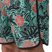 Close-up of the lower right leg of Fayder Boardshort showing vibrant floral pattern and REEF logo facing forward.