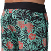 Close-up of the front left side of Fayder Boardshort featuring tropical print and black waistband for beach comfort.
