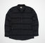 Front view of the Bartlett Woven Jacket in black with subtle stripes, featuring a button-up design and collar.