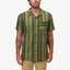 Front view of a man wearing the green striped Angelo Short Sleeve Camp Shirt, beach-inspired casual apparel.