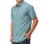 Male model wearing a teal Hartman Woven Shirt with a surf-inspired pattern, highlighted from the front torso view.