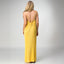 Woman wearing a yellow Plisse Dress facing away, showing back tie detail and lightweight, comfortable fabric flow.