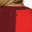 Close-up of the back neckline of the Carrie Sweater showing knit texture in maroon and orange colors.