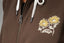 Close-up of chest area on Misty Fleece Full Zip showing embroidered yellow flowers and REEF logo on brown fabric with white drawstrings.