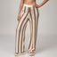 Front view of Mika Sweater Pant in brown and white stripes with soft cushioned beach sandals for women