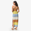 Woman wearing a striped Gia Maxi Dress facing away, showcasing the back design and beach-inspired comfort style.