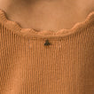 Close-up of the scalloped neckline detail on the Gia Maxi Dress in soft knit fabric, featuring surf-inspired comfort.