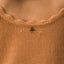 Close-up of the scalloped neckline detail on the Gia Maxi Dress in soft knit fabric, featuring surf-inspired comfort.