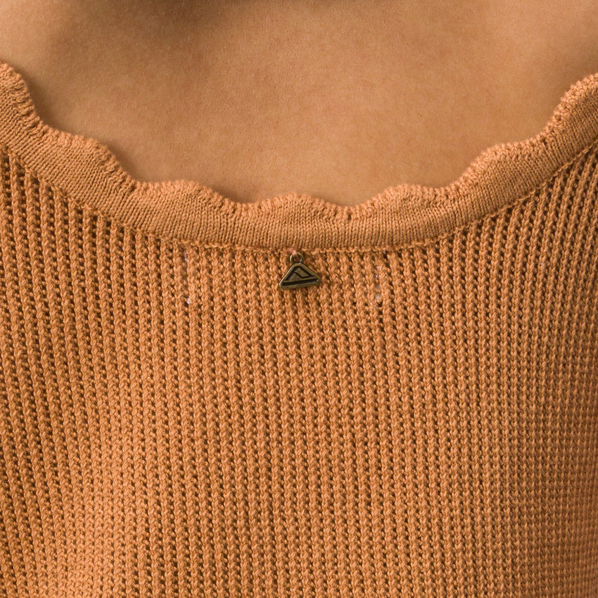 Close-up of the scalloped neckline detail on the Gia Maxi Dress in soft knit fabric, featuring surf-inspired comfort.