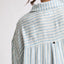 Back view close-up of light blue and white striped fabric on the Ollie Striped Shirt Dress, highlighting texture and collar.
