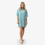 Woman wearing Ollie Shirt Dress in blue and white stripes, front view, paired with beach-inspired sandals facing forward.