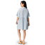 Woman wearing a light blue Lainey Shirt Dress seen from the back, paired with beige platform sandals facing right.