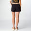 Woman wearing black Robyn Short from the back, standing straight with feet facing forward, highlighting comfort and fit.
