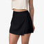 Woman wearing a black Tori Linen Wrap Skort showing front and side with a surf-inspired, comfortable style