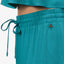Close-up of the waistband and drawstring of the teal Ollie Pant for women, surf-inspired comfort and style.
