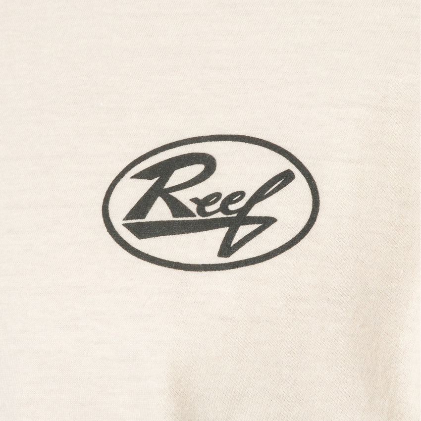 Close-up of cream-colored fabric with black Reef logo print on front of Auto Tee for men
