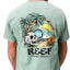 Akin Tee on a man, back view, featuring a beach graphic with palm trees, waves, a skull, and reef branding.