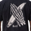 Close-up of the back of the Pray Tee showing a skeleton hand holding a surfboard print on black fabric.