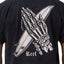 Close-up of the back of the Pray Tee showing a skeleton hand holding a surfboard print on black fabric.