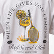 Close-up of the Social Boyfriend Crew tee’s back graphic with lemon drink and tennis racquet, surf-inspired comfort style.