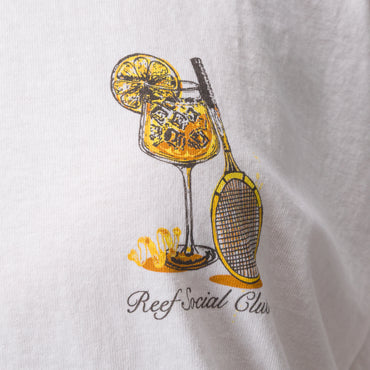 Close-up of Social Boyfriend Crew white shirt showing yellow and black tennis racket and drink graphic on chest.