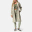 Woman wearing Beverly Knit Trench in desert sage plaid, facing front, showcasing long plaid trench coat with relaxed fit.