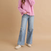 Woman wearing Boardwalk Callie shoes facing forward, shown in a full-body casual outfit with jeans and a pink sweater.