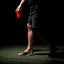 Side view of a man's feet wearing black and red Fanning Pregame sandals, showcasing comfort and surf-inspired design.